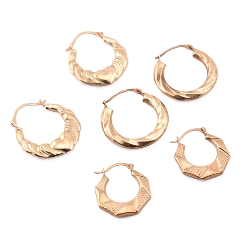 281 - Three pairs of 9ct gold hoop earrings.The lot to include a pair of 9ct gold hoop earrings with heart... 