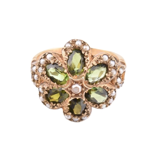 288 - A hallmarked 9ct gold green stone and seed pearl cluster ring. The 9ct yellow gold ring set with a c... 