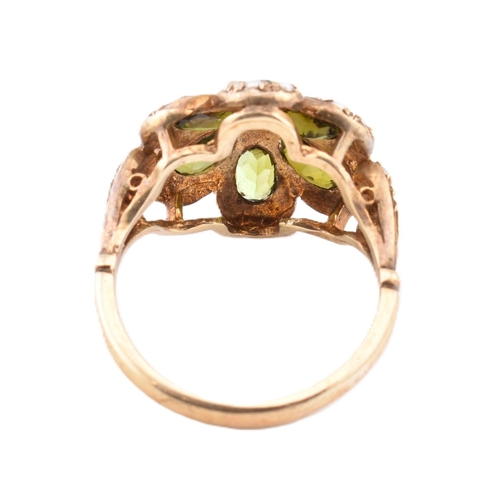 288 - A hallmarked 9ct gold green stone and seed pearl cluster ring. The 9ct yellow gold ring set with a c... 