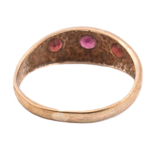 291 - A hallmarked 9ct gold and red stone gypsy ring. The 9ct yellow gold gypsy ring set with three star s... 