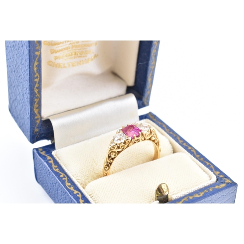 3 - An early 20th-century ruby and diamond ring. The ring set with a central cushion cut ruby flanked by... 