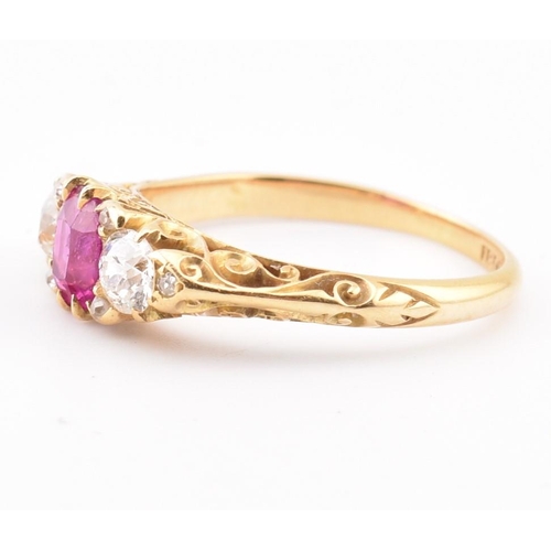 3 - An early 20th-century ruby and diamond ring. The ring set with a central cushion cut ruby flanked by... 