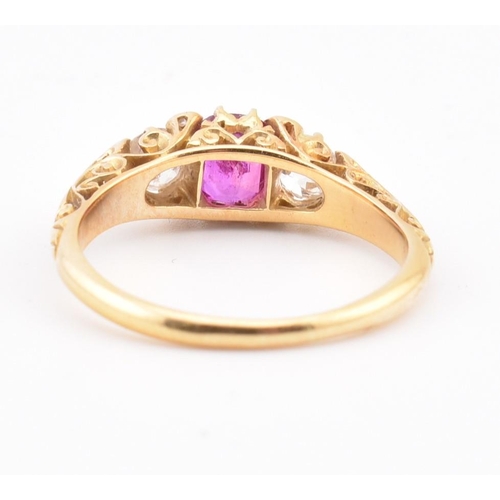 3 - An early 20th-century ruby and diamond ring. The ring set with a central cushion cut ruby flanked by... 