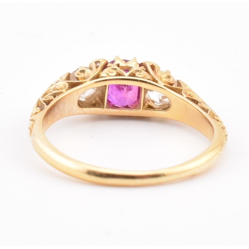 3 - An early 20th-century ruby and diamond ring. The ring set with a central cushion cut ruby flanked by... 