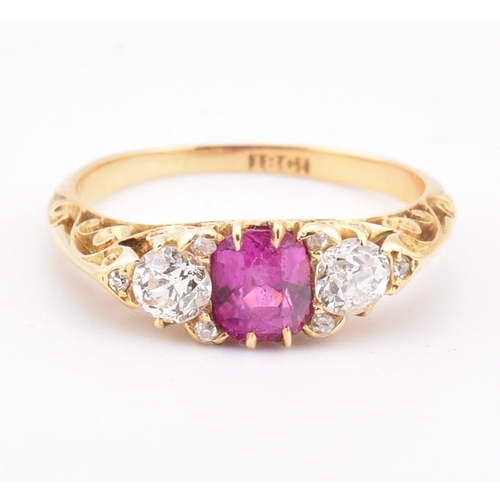 3 - An early 20th-century ruby and diamond ring. The ring set with a central cushion cut ruby flanked by... 