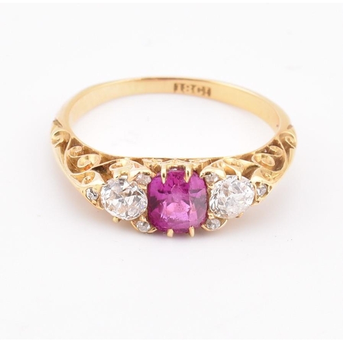 3 - An early 20th-century ruby and diamond ring. The ring set with a central cushion cut ruby flanked by... 