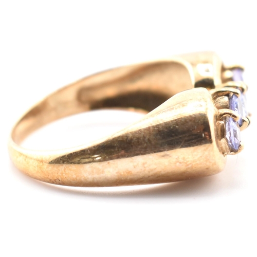 314 - A hallmarked 9ct gold and tanzanite line ring. The 9ct yellow gold ring having five round cut tanzan... 