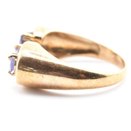 314 - A hallmarked 9ct gold and tanzanite line ring. The 9ct yellow gold ring having five round cut tanzan... 