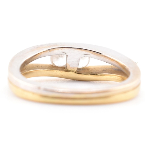 316 - An 18ct bi-colour gold & CZ two stone ring. The 18ct gold bi-colour ring having two channel set ... 