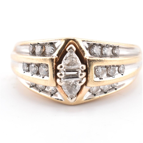 318 - A gold and diamond fancy cluster ring. The yellow gold ring set with a central east-west baguette cu... 