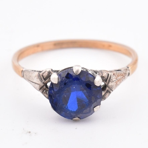 324 - An 18ct gold and blue stone ring. The 18ct gold ring set with a single six claw set round cut blue s... 