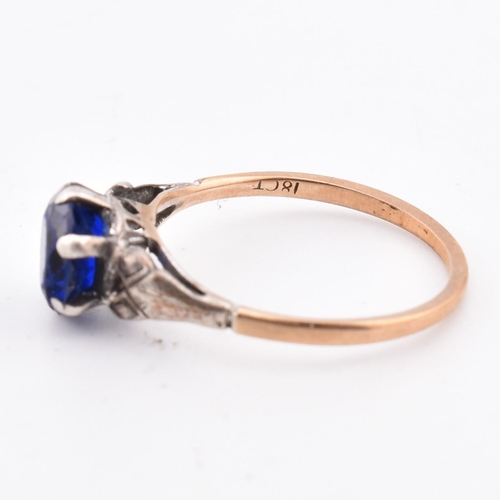 324 - An 18ct gold and blue stone ring. The 18ct gold ring set with a single six claw set round cut blue s... 