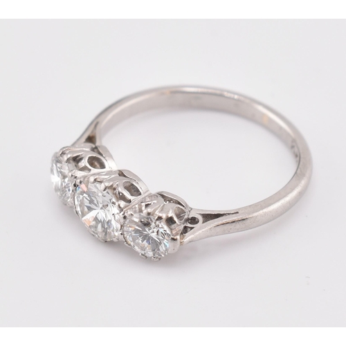 326 - A platinum and diamond three-stone ring. The trilogy ring having three claw set round brilliant cut ... 