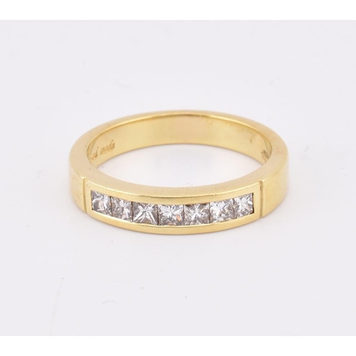 33 - A hallmarked 'hand made' 18ct gold diamond half eternity ring. The ring mounted with 7 channel set p... 