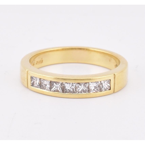 33 - A hallmarked 'hand made' 18ct gold diamond half eternity ring. The ring mounted with 7 channel set p... 