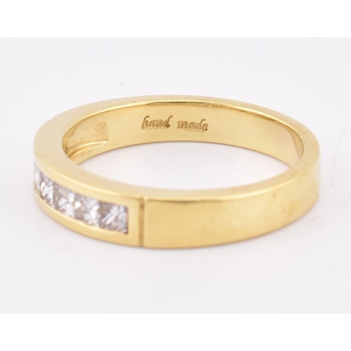 33 - A hallmarked 'hand made' 18ct gold diamond half eternity ring. The ring mounted with 7 channel set p... 