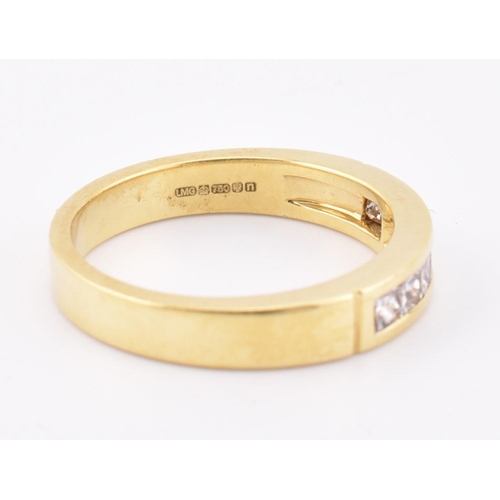 33 - A hallmarked 'hand made' 18ct gold diamond half eternity ring. The ring mounted with 7 channel set p... 