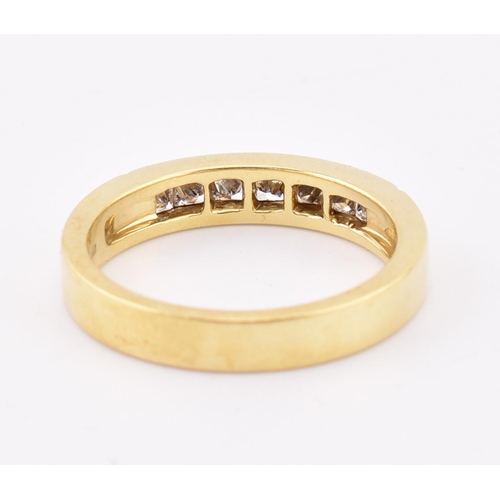 33 - A hallmarked 'hand made' 18ct gold diamond half eternity ring. The ring mounted with 7 channel set p... 