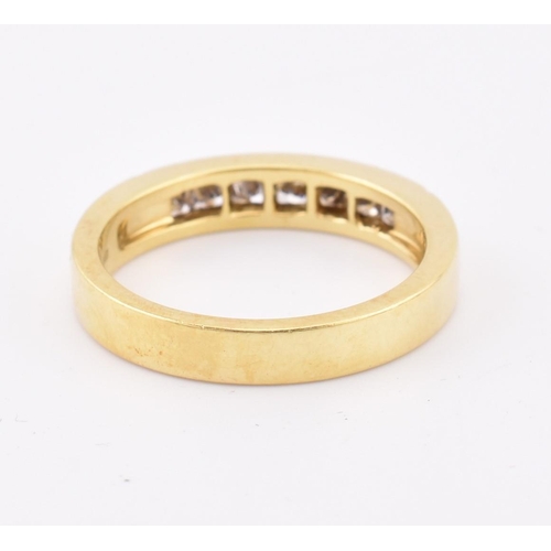 33 - A hallmarked 'hand made' 18ct gold diamond half eternity ring. The ring mounted with 7 channel set p... 