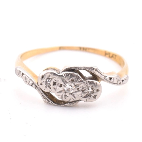 343 - An 18ct gold and platinum diamond crossover ring. The 18ct yellow gold ring having three graduating ... 