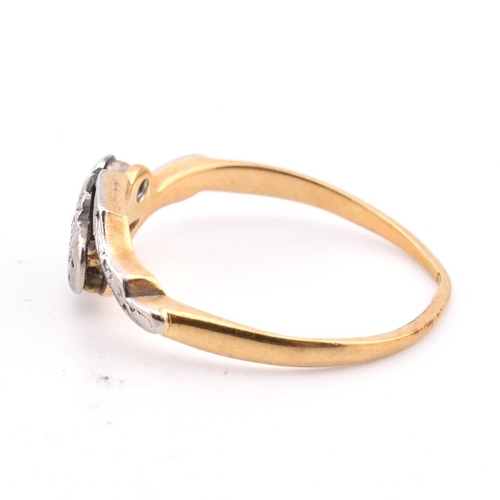 343 - An 18ct gold and platinum diamond crossover ring. The 18ct yellow gold ring having three graduating ... 