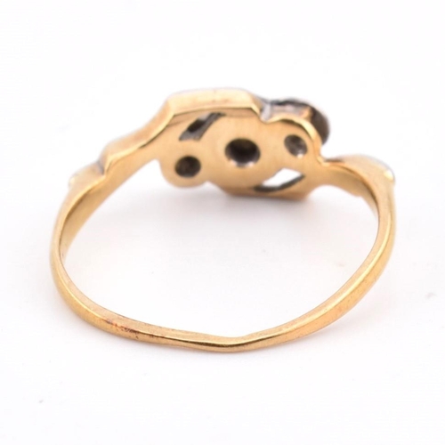 343 - An 18ct gold and platinum diamond crossover ring. The 18ct yellow gold ring having three graduating ... 