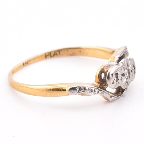 343 - An 18ct gold and platinum diamond crossover ring. The 18ct yellow gold ring having three graduating ... 