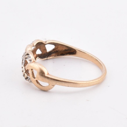 346 - A hallmarked 9ct gold and diamond ring AF. The 9ct yellow gold ring having a pierced, weaved design ... 