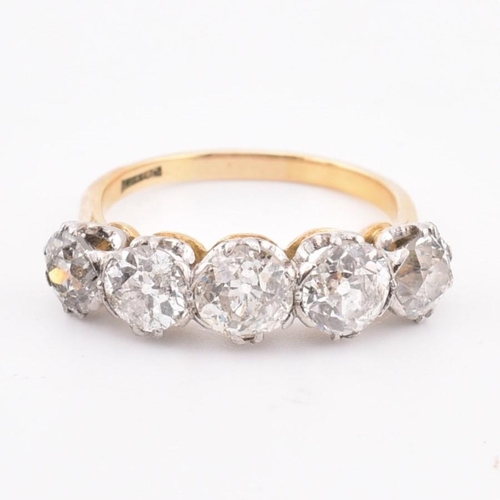 35 - An early 20th century18ct gold and platinum five stone diamond ring. The ring set with five double c... 