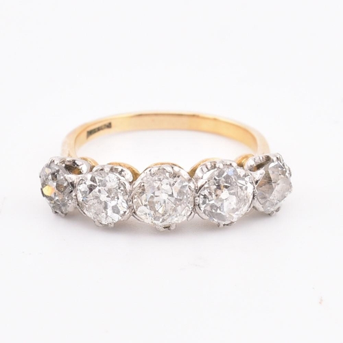 35 - An early 20th century18ct gold and platinum five stone diamond ring. The ring set with five double c... 