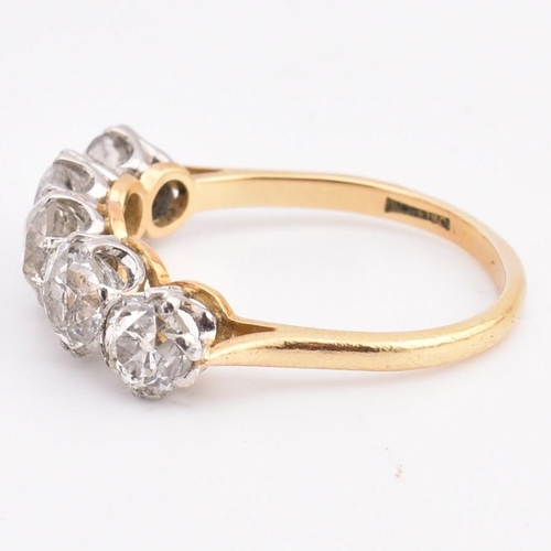 35 - An early 20th century18ct gold and platinum five stone diamond ring. The ring set with five double c... 