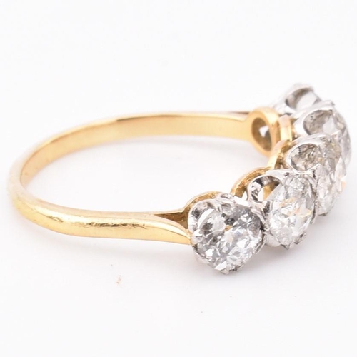 35 - An early 20th century18ct gold and platinum five stone diamond ring. The ring set with five double c... 