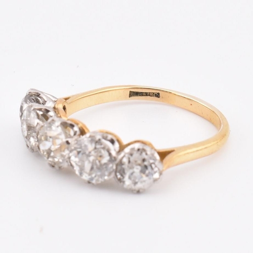 35 - An early 20th century18ct gold and platinum five stone diamond ring. The ring set with five double c... 