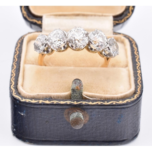 35 - An early 20th century18ct gold and platinum five stone diamond ring. The ring set with five double c... 