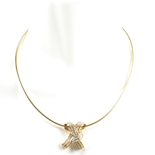 350 - A 14ct gold and diamond ribbon bow pendant necklace. The necklace is strung with a ribbon bow pendan... 