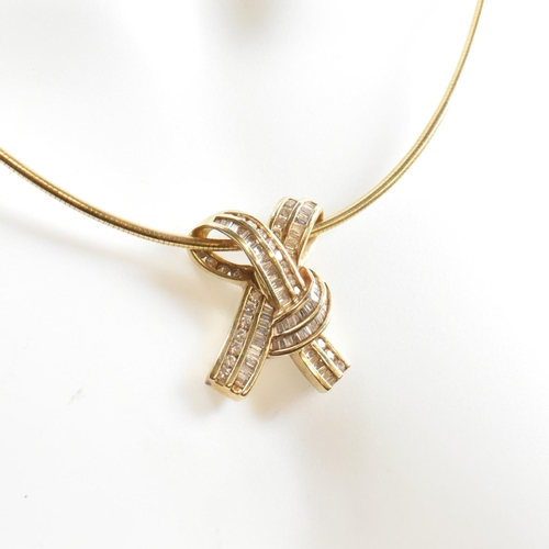 350 - A 14ct gold and diamond ribbon bow pendant necklace. The necklace is strung with a ribbon bow pendan... 