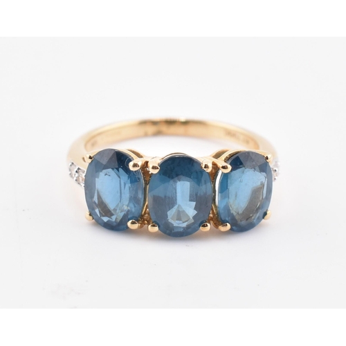 353 - A hallmarked 9ct gold, Orissa kyanite and white zircon three stone ring. The 9ct yellow gold ring se... 