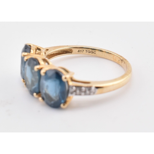 353 - A hallmarked 9ct gold, Orissa kyanite and white zircon three stone ring. The 9ct yellow gold ring se... 