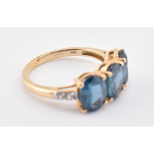 353 - A hallmarked 9ct gold, Orissa kyanite and white zircon three stone ring. The 9ct yellow gold ring se... 