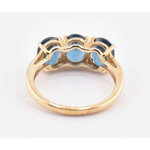 353 - A hallmarked 9ct gold, Orissa kyanite and white zircon three stone ring. The 9ct yellow gold ring se... 