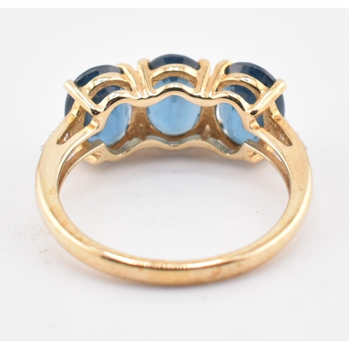 353 - A hallmarked 9ct gold, Orissa kyanite and white zircon three stone ring. The 9ct yellow gold ring se... 