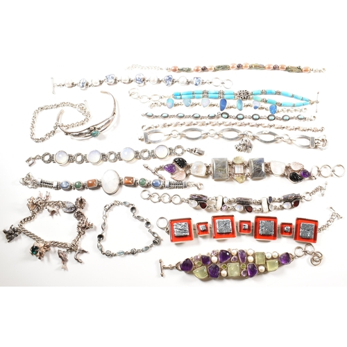 354 - A quantity of silver gem set bracelets and a cuff bangle. The bracelets include charm, gem set pearl... 