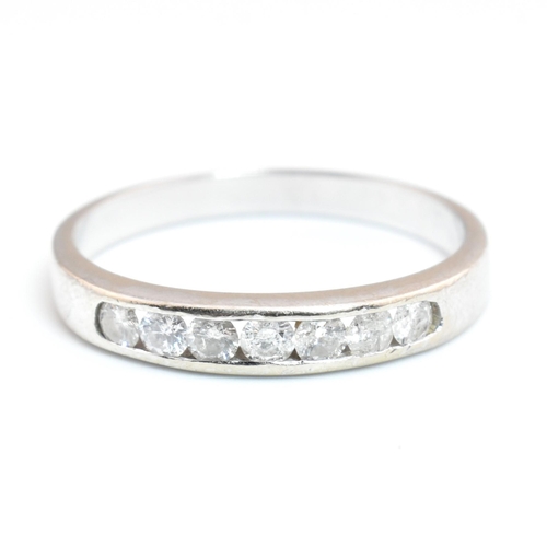 373 - A hallmarked 9ct white gold and diamond half eternity ring. The 9ct white gold ring having seven cha... 