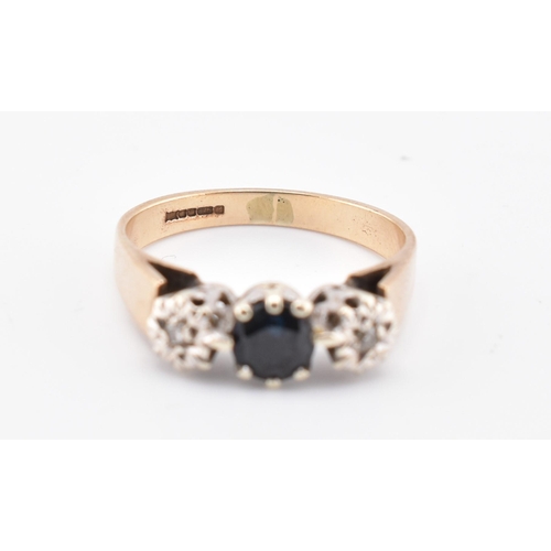 383 - A hallmarked 9ct gold, sapphire and diamond three-stone ring. The 9ct yellow gold ring set with a ce... 