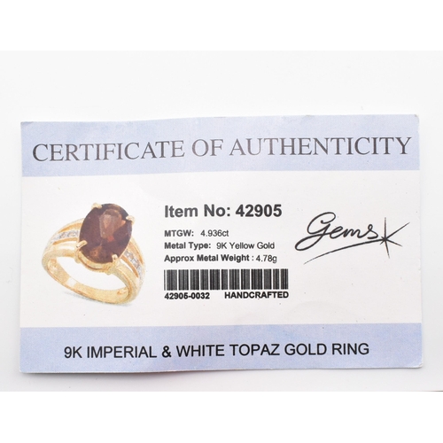 386 - A hallmarked 9ct gold imperial topaz and white topaz ring. The 9ct yellow gold ring set with a centr... 