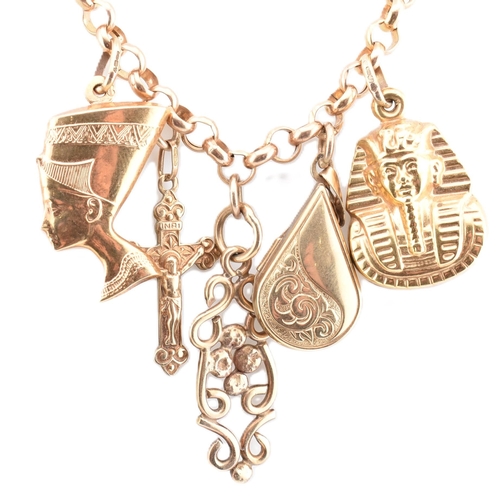 393 - A hallmarked 9ct gold pendant charm necklace. The yellow gold charm necklace adorned with charms to ... 