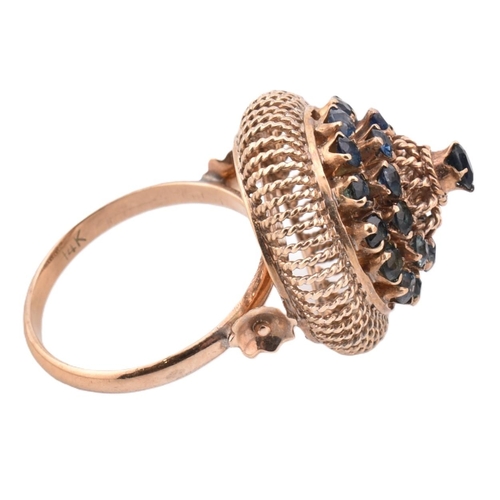 395 - 14ct gold and sapphire cluster ring. The 14ct gold ring having a central claw set round cut sapphire... 