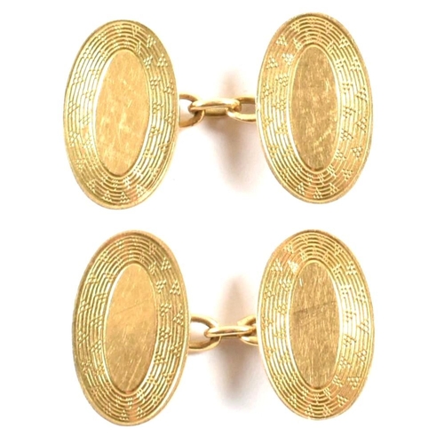 396 - A pair of hallmarked 18ct gold cufflinks. The cufflinks having oval decorated heads united by chain.... 