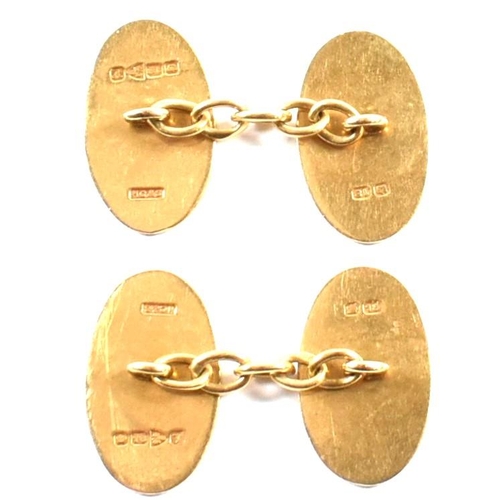 396 - A pair of hallmarked 18ct gold cufflinks. The cufflinks having oval decorated heads united by chain.... 