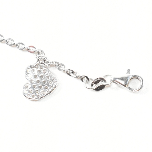 398 - A hallmarked 9ct white gold and CZ heart charm bracelet. The cable link chain bracelet having four C... 